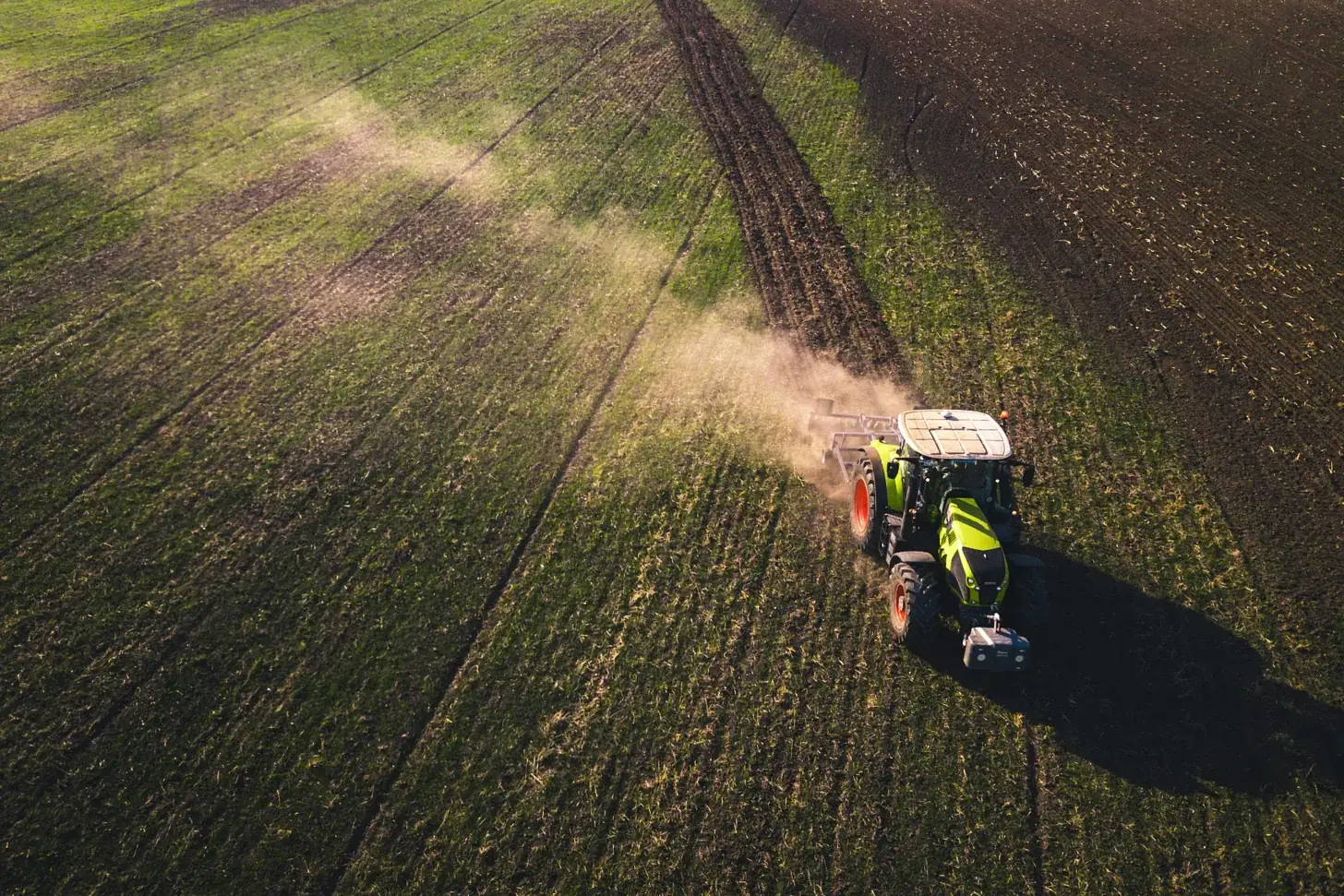 A tractor working a European field, seen from above